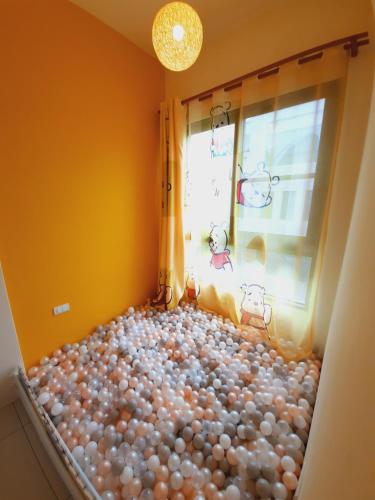 a room filled with balls in front of a window at 3Kiss Homestay in Wujie