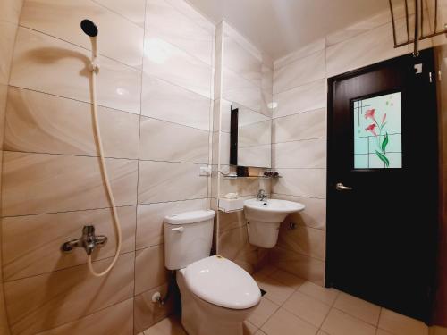 a bathroom with a toilet and a sink at 3Kiss Homestay in Wujie