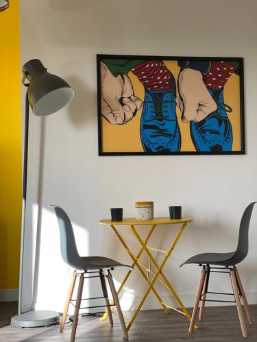 a room with two chairs and a table and a painting at VANNUCCI 71 APT in Perugia