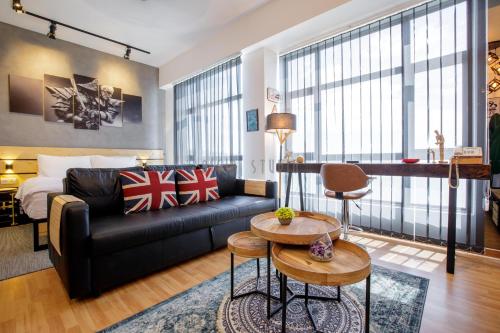 a living room with a couch and a bed at AISI3 Studio Seaview at Tanjung Lumpur in Kuantan