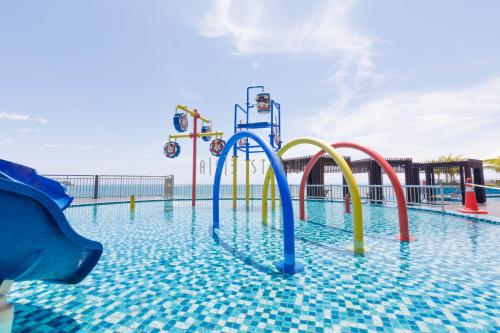 a pool with a water park with a water slide at AISI3 Studio Seaview at Tanjung Lumpur in Kuantan