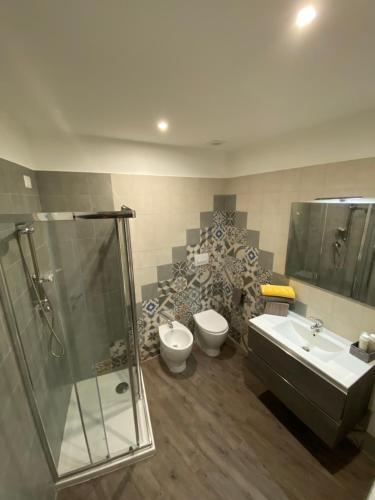 a bathroom with a shower and a toilet and a sink at VANNUCCI 71 APT in Perugia