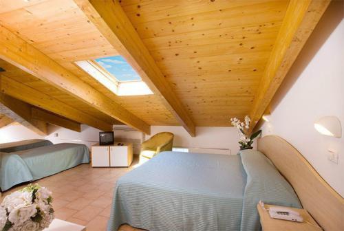 a attic bedroom with a bed and a skylight at Mansarda Cannes in Riccione
