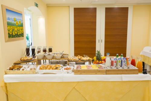 a buffet of food on a table in a room at Mansarda Cannes in Riccione
