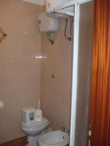 a small bathroom with a toilet and a sink at La Casa di Anna in Lampedusa