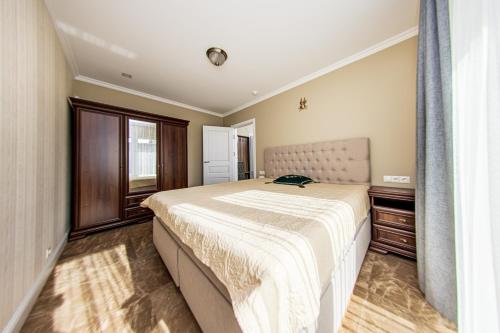 a bedroom with a large bed and a window at Sakura_INN Palanga in Palanga