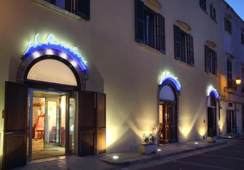 a store with blue lights on the side of a building at Al Pescatore Hotel & Restaurant in Gallipoli