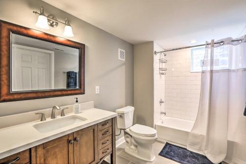 a bathroom with a sink and a toilet and a mirror at Cozy-Chic Cincy Apartment Less Than 4 Mi to Dtwn and Stadium in Cincinnati