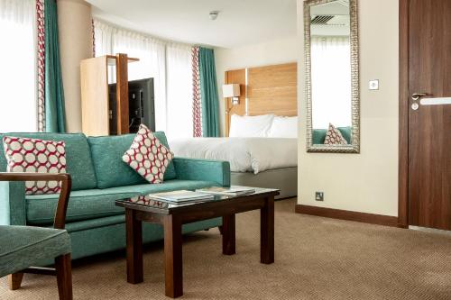 a hotel room with a couch and a bed at Waterfront Southport Hotel in Southport