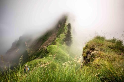 a misty mountain with two people standing on top of it at Hotel St Hubertus in Egg