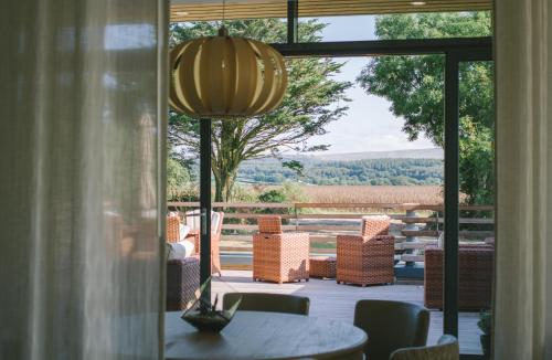 a room with a table and chairs and a large window at Boringdon Hall Hotel and Spa in Plymouth