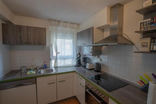 a kitchen with a sink and a counter top at Fewo Reutlingen Metzstraße OG 1 in Reutlingen