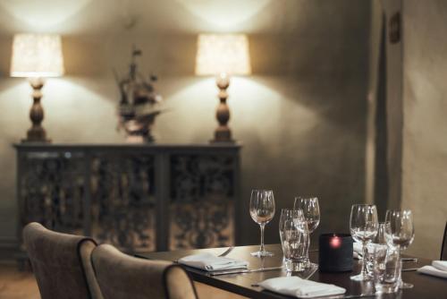 a table with wine glasses and a candle on it at Boringdon Hall Hotel and Spa in Plymouth
