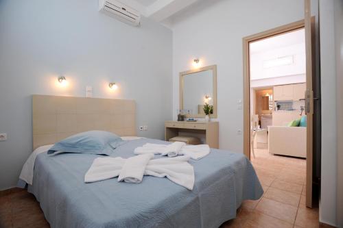 a bedroom with a bed with towels on it at Aigaio Studios tinos in Tinos Town