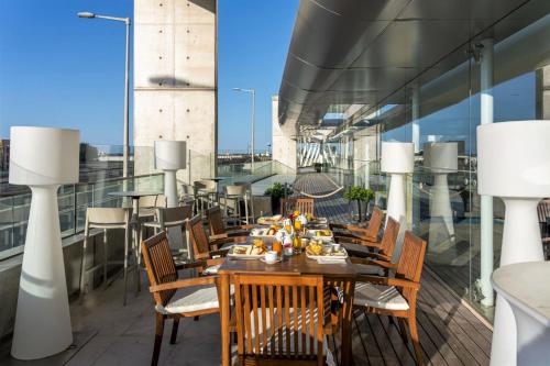 a table with food on it on a balcony at Hotel Marina Atlântico in Ponta Delgada