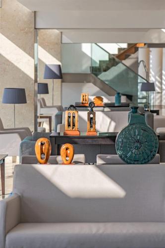 a living room with orange pumpkins on a table at Hotel Marina Atlântico in Ponta Delgada
