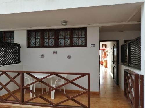a kitchen with a table and a white wall at Apartamento Neptuno playa 12 in Puerto de Santiago