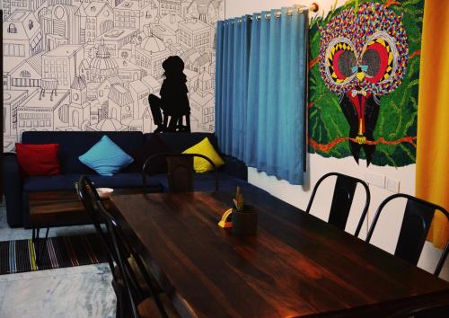 a living room with a table and a couch at The Hood Hostel in Bangalore