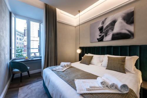 a bedroom with a bed with towels on it at Growel Exclusive Suites San Pietro in Rome