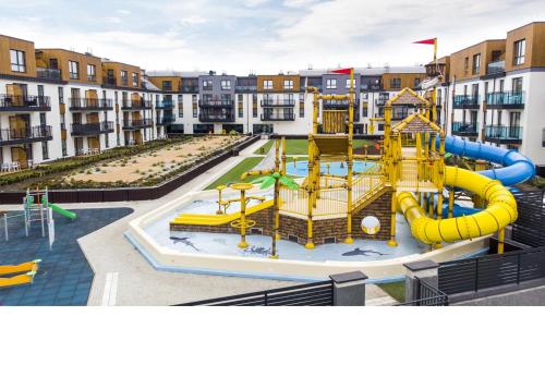 a playground in the middle of a apartment complex at Bel Mare Apartament 128 z ogródkiem in Międzyzdroje