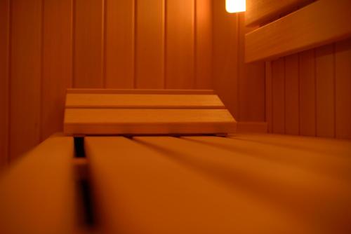 a wooden bench in a room with a light at Hotel Al Convento in Vezzano Ligure