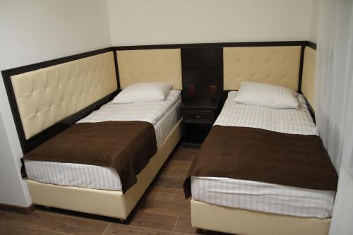 two beds in a small room at Купецький Двір in Mizhhirʼʼya