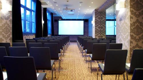 a conference room with chairs and a projection screen at Malmaison Newcastle in Newcastle upon Tyne