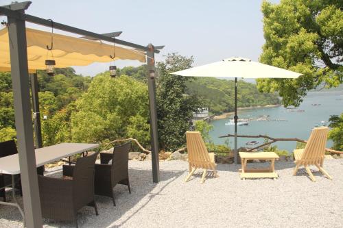a group of chairs and a table with an umbrella at GranGlam - Vacation STAY 24973v in Susaki