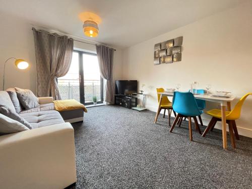 a living room with a couch and a table at Grand Central Apartments in Derby