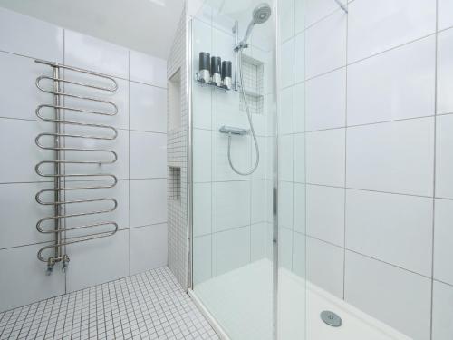 a white bathroom with a shower with a glass door at John's House in York
