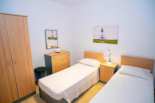 Säng eller sängar i ett rum på Seaside Apartments Malta Mellieha1