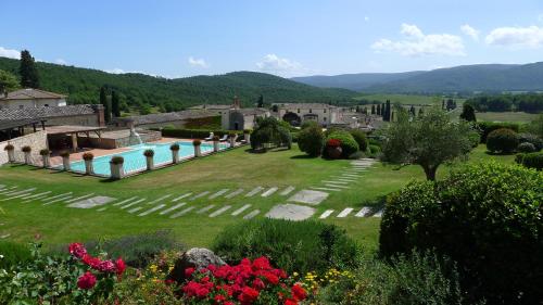 a garden with a swimming pool in a resort at La Bagnaia Golf Resort in Bagnaia