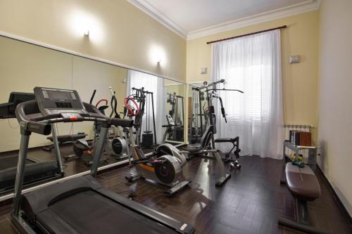 a gym with several exercise bikes and a mirror at Hotel Ambasciatori in Palermo