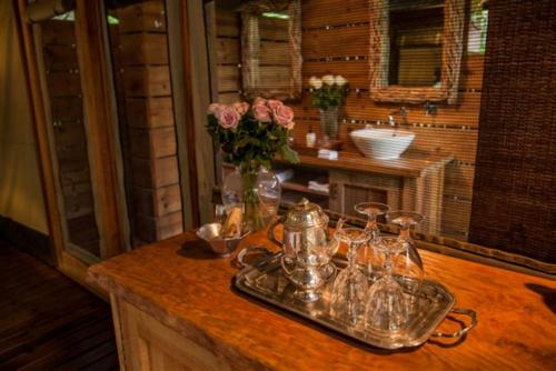 a kitchen counter with a vase of flowers on it at Summerfields Rose Retreat and Spa in Hazyview