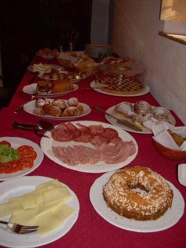a table topped with plates of different types of food at Hotel Tempio di Apollo in Olgiata