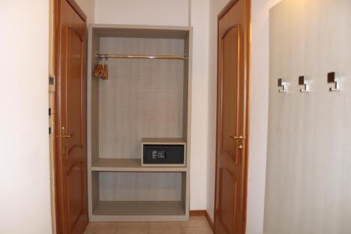 a walk in closet with a clock on a shelf at Artemisia Palace Hotel in Palermo