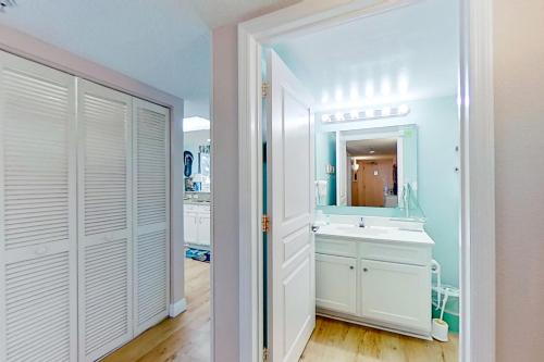 a bathroom with a sink and a mirror at Bay Watch 0232 in Myrtle Beach