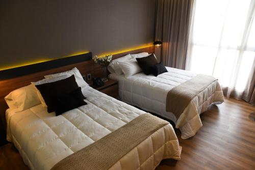 Tempat tidur dalam kamar di Hotel Soho Suites