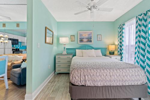 a bedroom with a bed and a blue wall at Bay Watch 0631 in Myrtle Beach