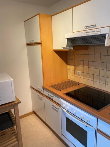 a kitchen with white appliances and a stove top oven at le coeur de ville in Dinant