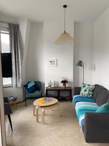 a living room with a couch and a table at le coeur de ville in Dinant