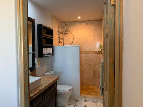 a bathroom with a shower and a toilet and a sink at Ocean View Cabo Condo Create Memories!! in San José del Cabo