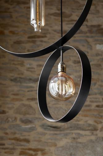 a glass light fixture hanging from a ceiling at La Metairie-du-Vauhariot - Vue Mer et Mont Saint Michel - Piscine Chauffée - Accès GR34 in Cancale