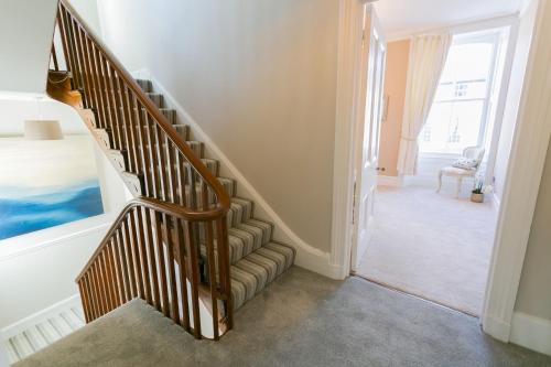 a winding staircase in a room with a window at Craig Hyfryd in Beaumaris