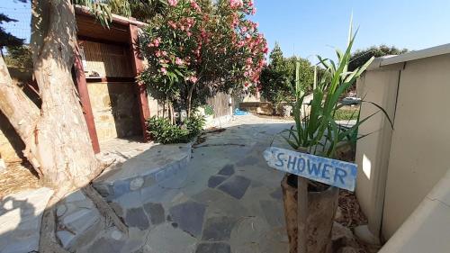 a house with a sign that says at Charly Point Villa in Methoni