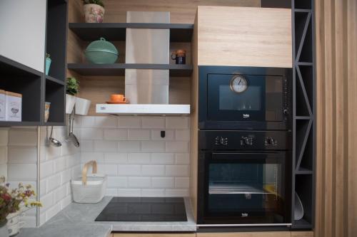 a kitchen with a black oven in a room at Apartment Dream Trebinje in Trebinje