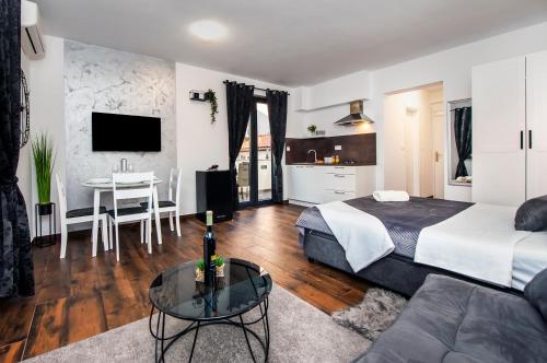 a hotel room with a bed and a table at Deluxe Apartments A&A in Rovinj