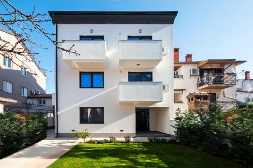 a house with white walls and windows at Deluxe Apartments A&A in Rovinj