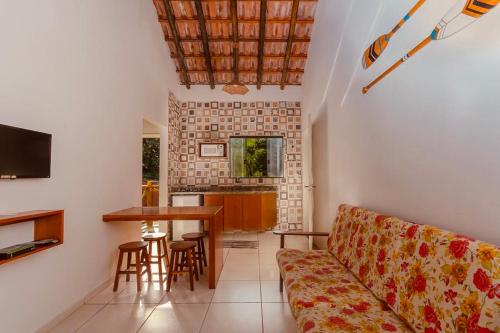 a living room with a couch and a table at Apartamentos Recanto da Barra in Ubatuba
