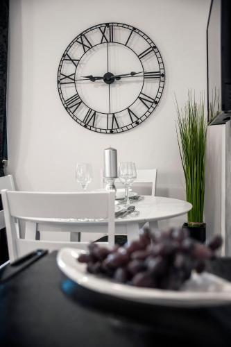 a plate of food on a table with a clock on the wall at Deluxe Apartments A&A in Rovinj